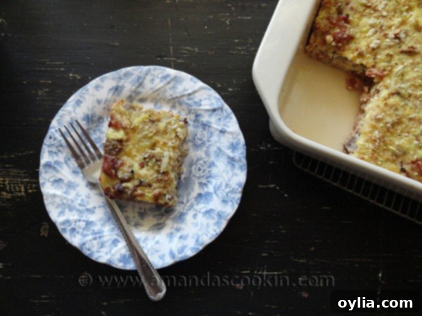 An overhead photo of a serving of golden-brown herbed breakfast stuffing casserole on a white and blue plate, garnished and ready to be enjoyed.