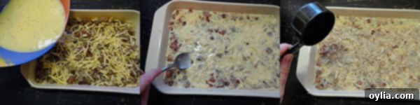 A close-up shot of the unbaked Herbed Breakfast Stuffing Casserole, showing the distinct layers of corned beef hash, stuffing mixture, cheese, and ready for the egg mixture to be poured over.