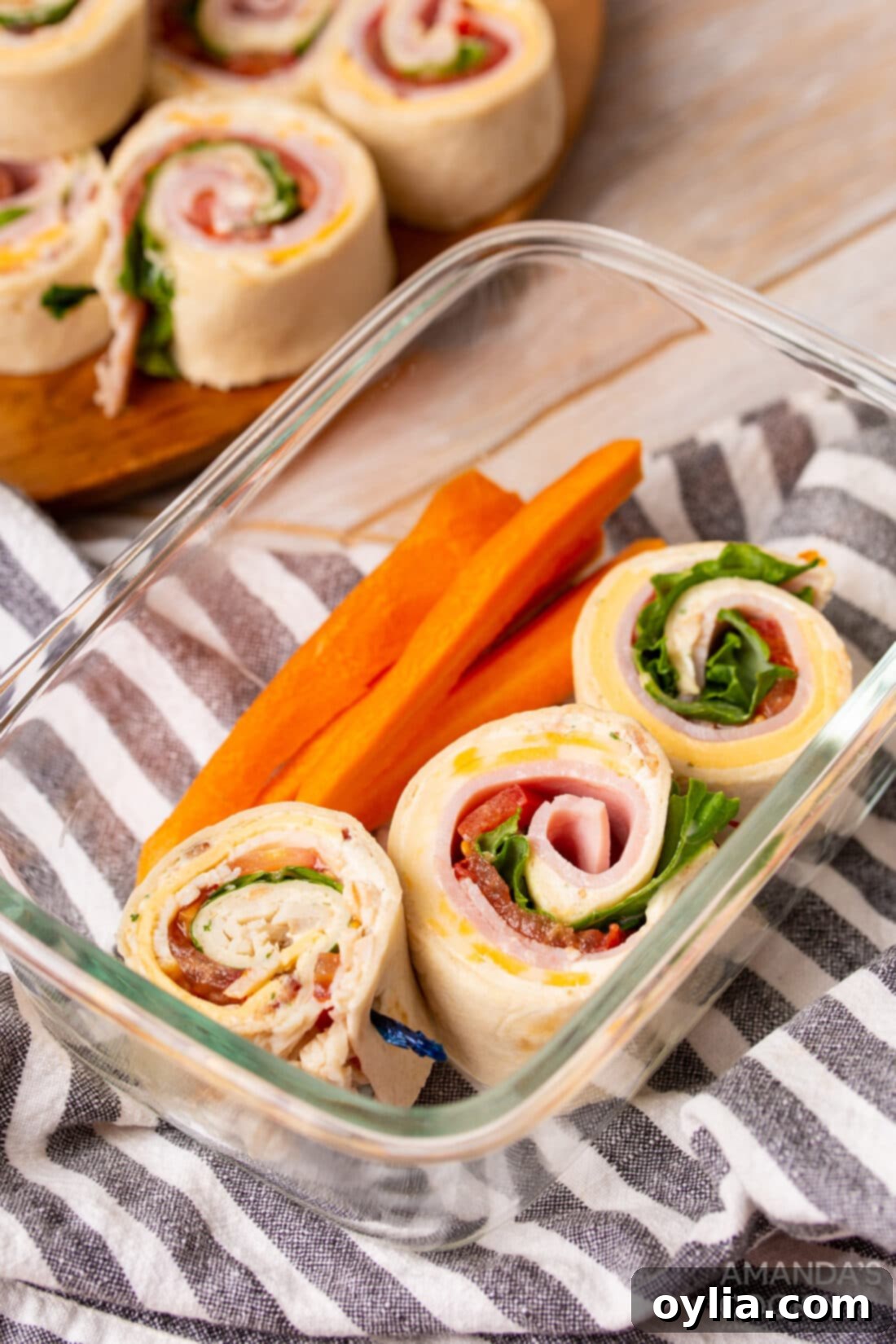 Pinwheel Sandwiches in a lunch container with carrots