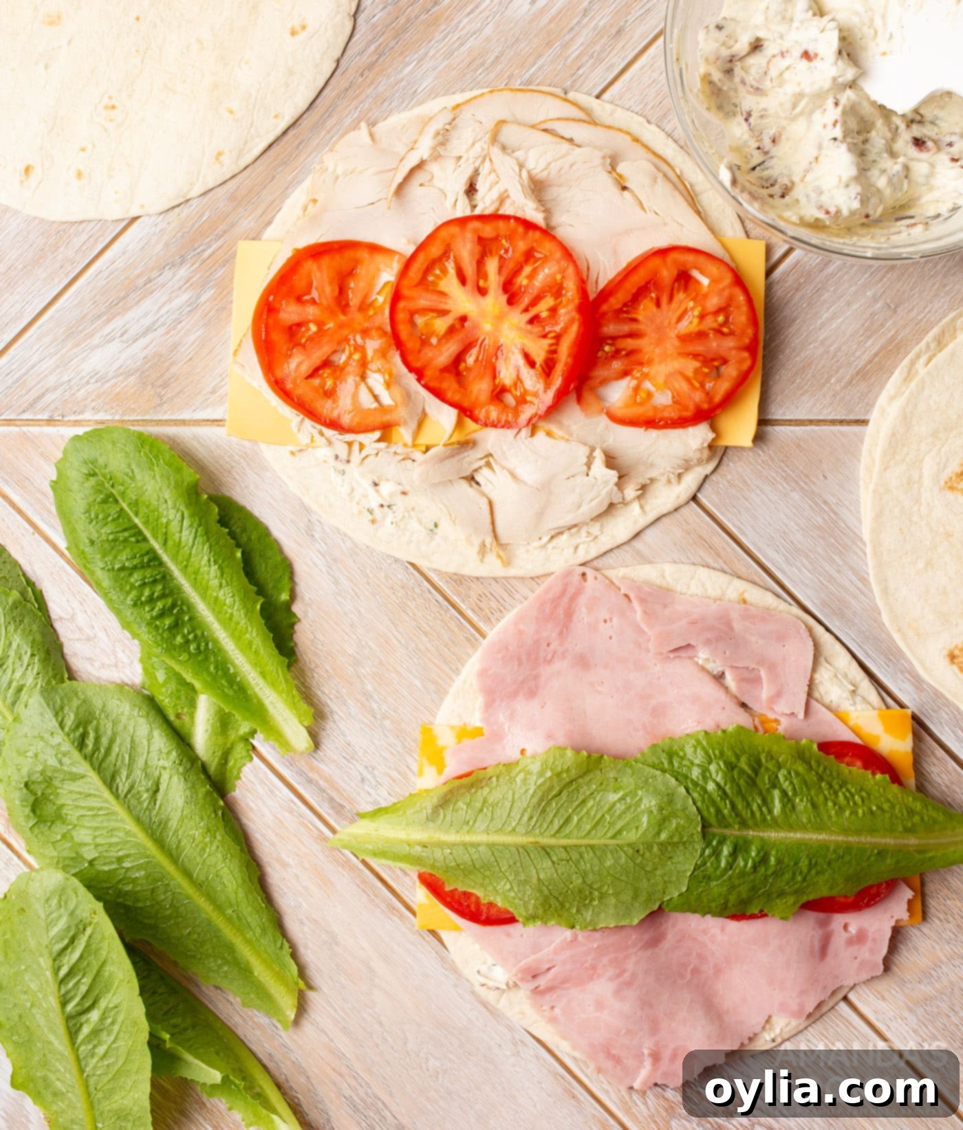 tomato and lettuce leaf on pinwheel sandwich tortillas