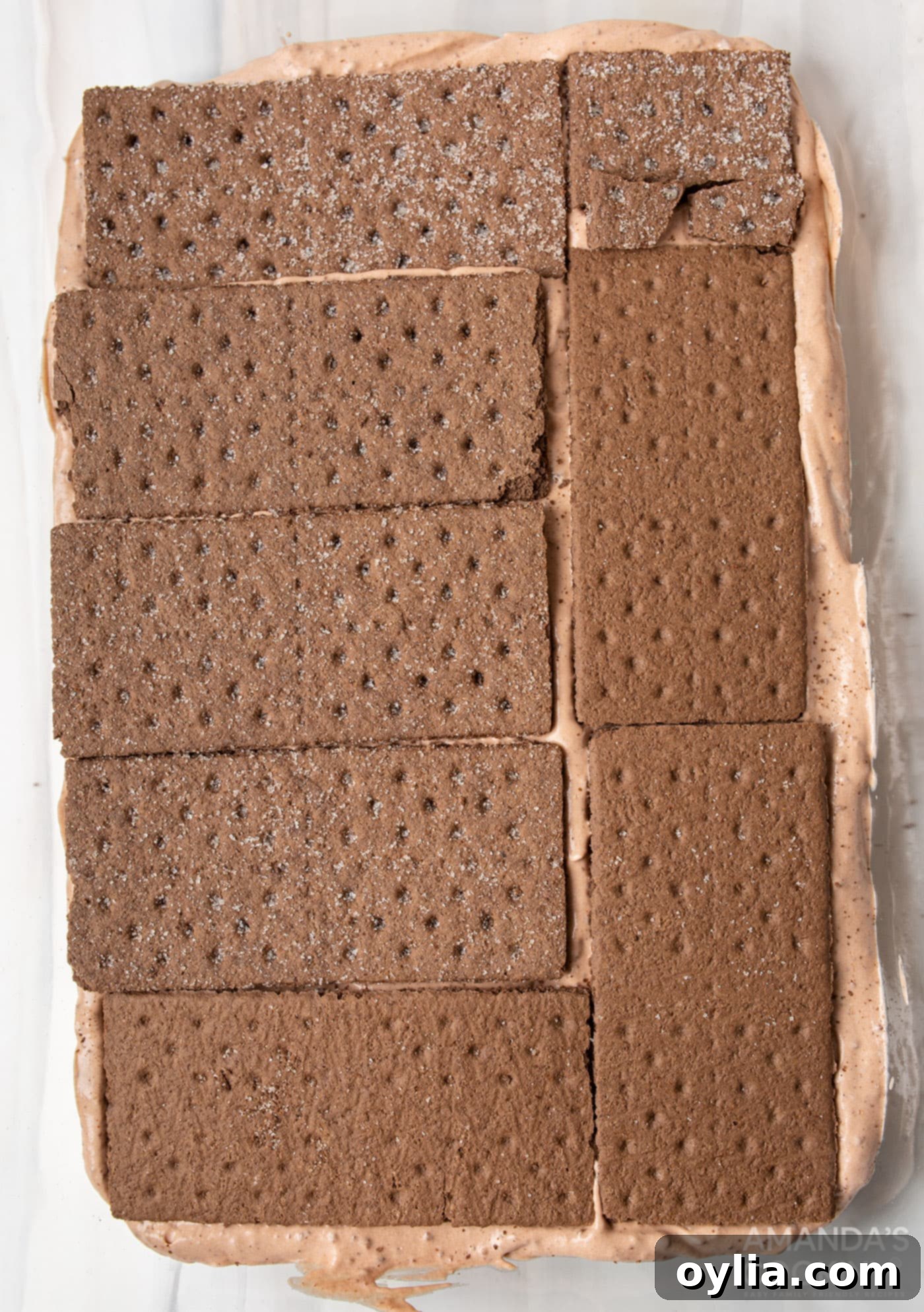 graham crackers on top of chocolate pudding mix in baking dish