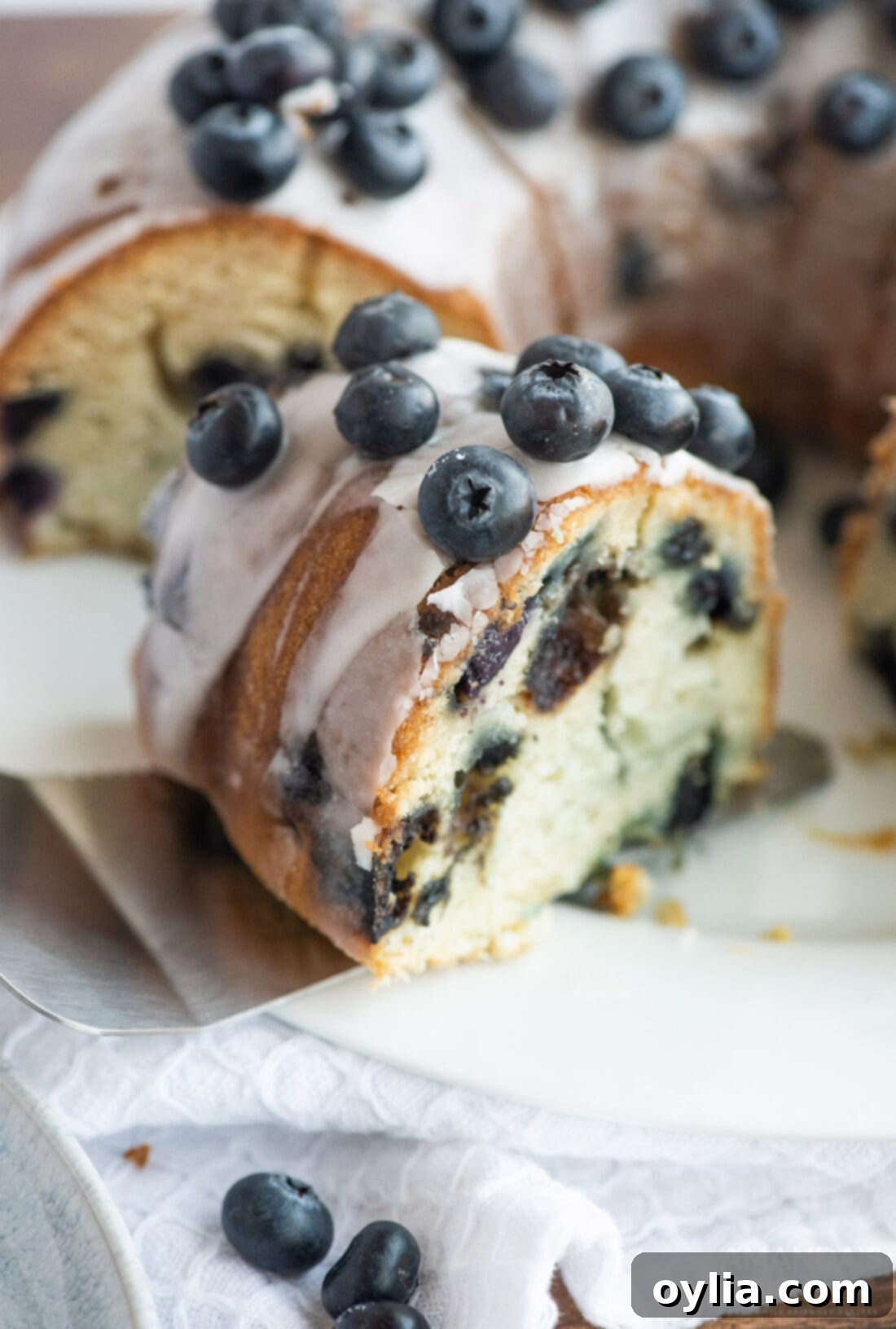 removing slice of Blueberry Bundt Cake from plate