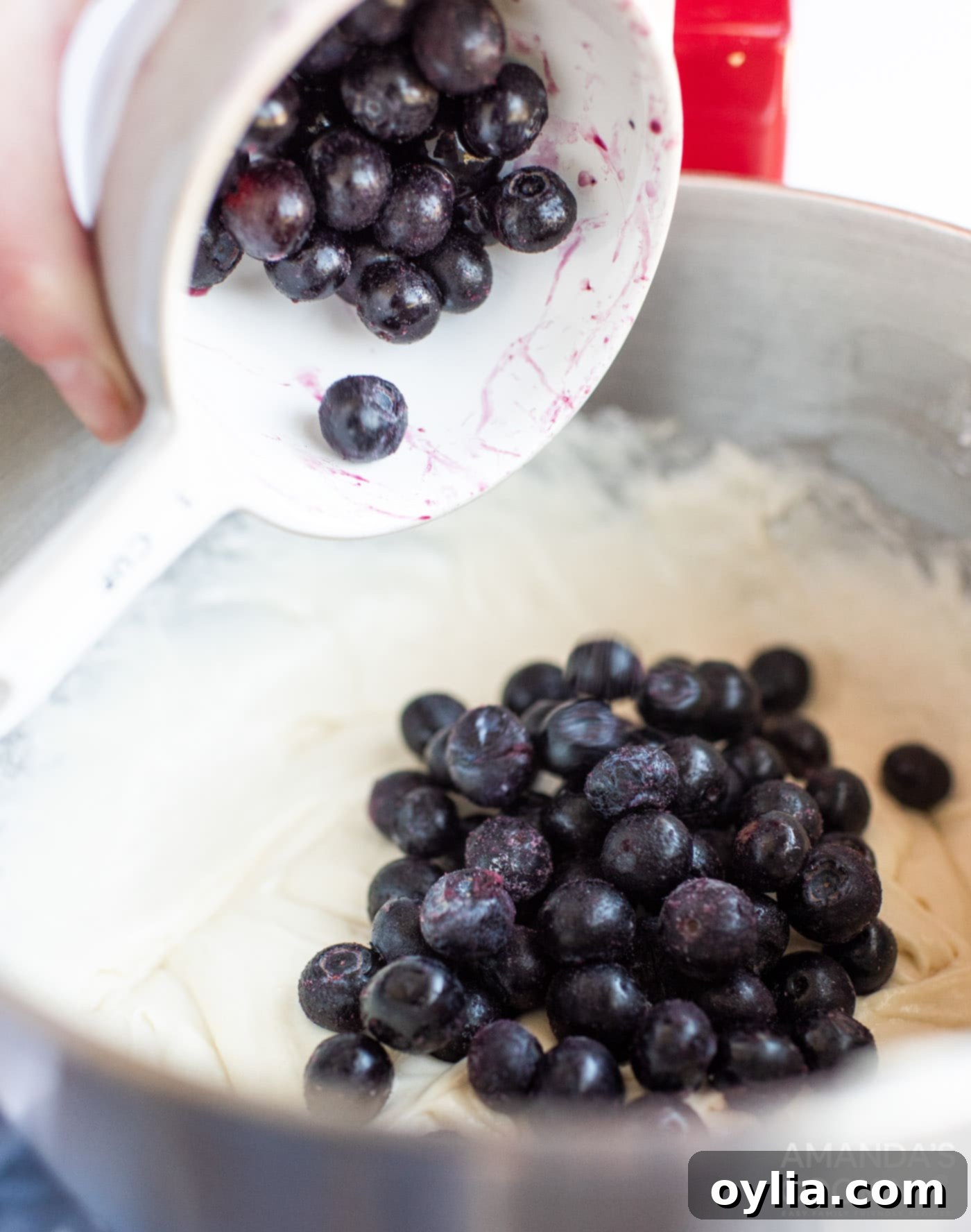 adding blueberries to cake batter