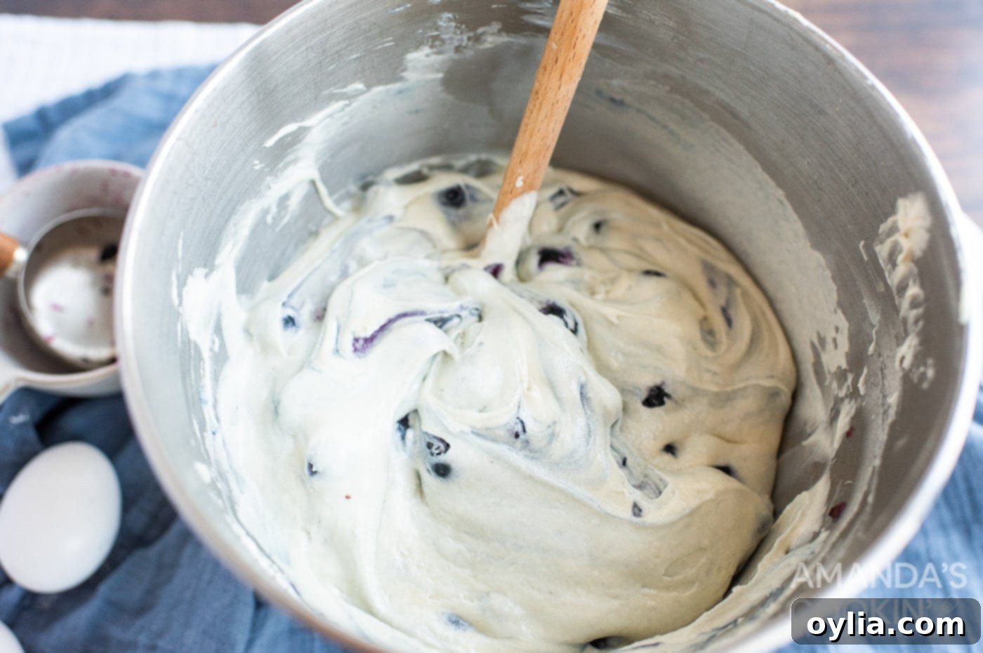 stirring blueberries into cake batter