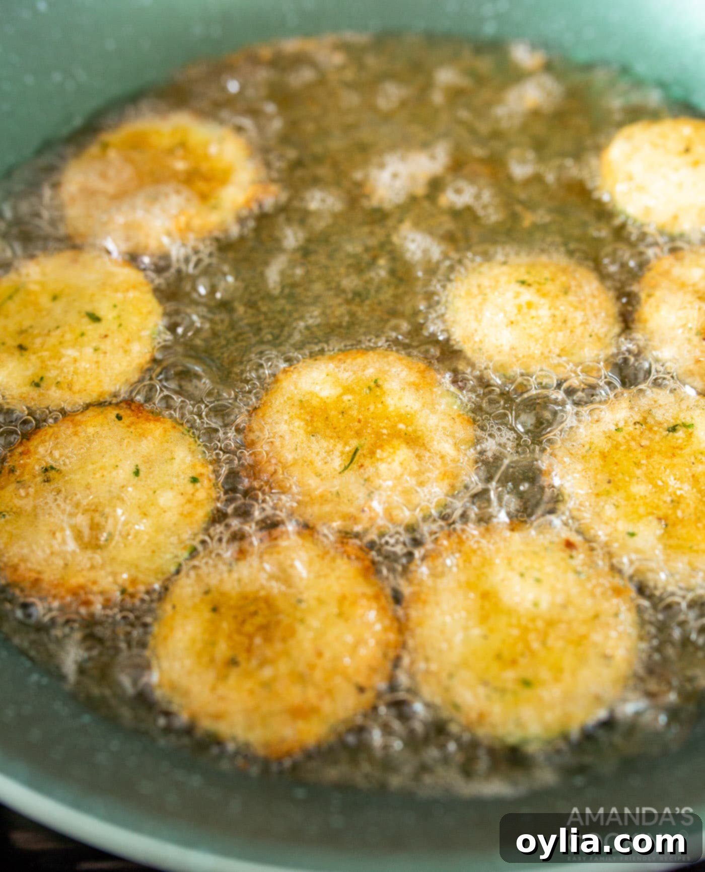 fried zucchini with oil in a skillet