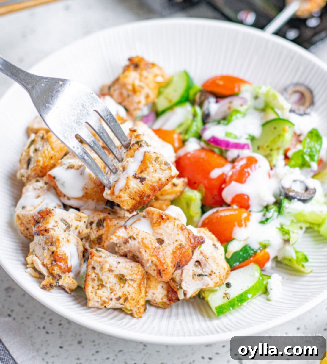 Plated Greek Chicken with a fresh Mediterranean salad