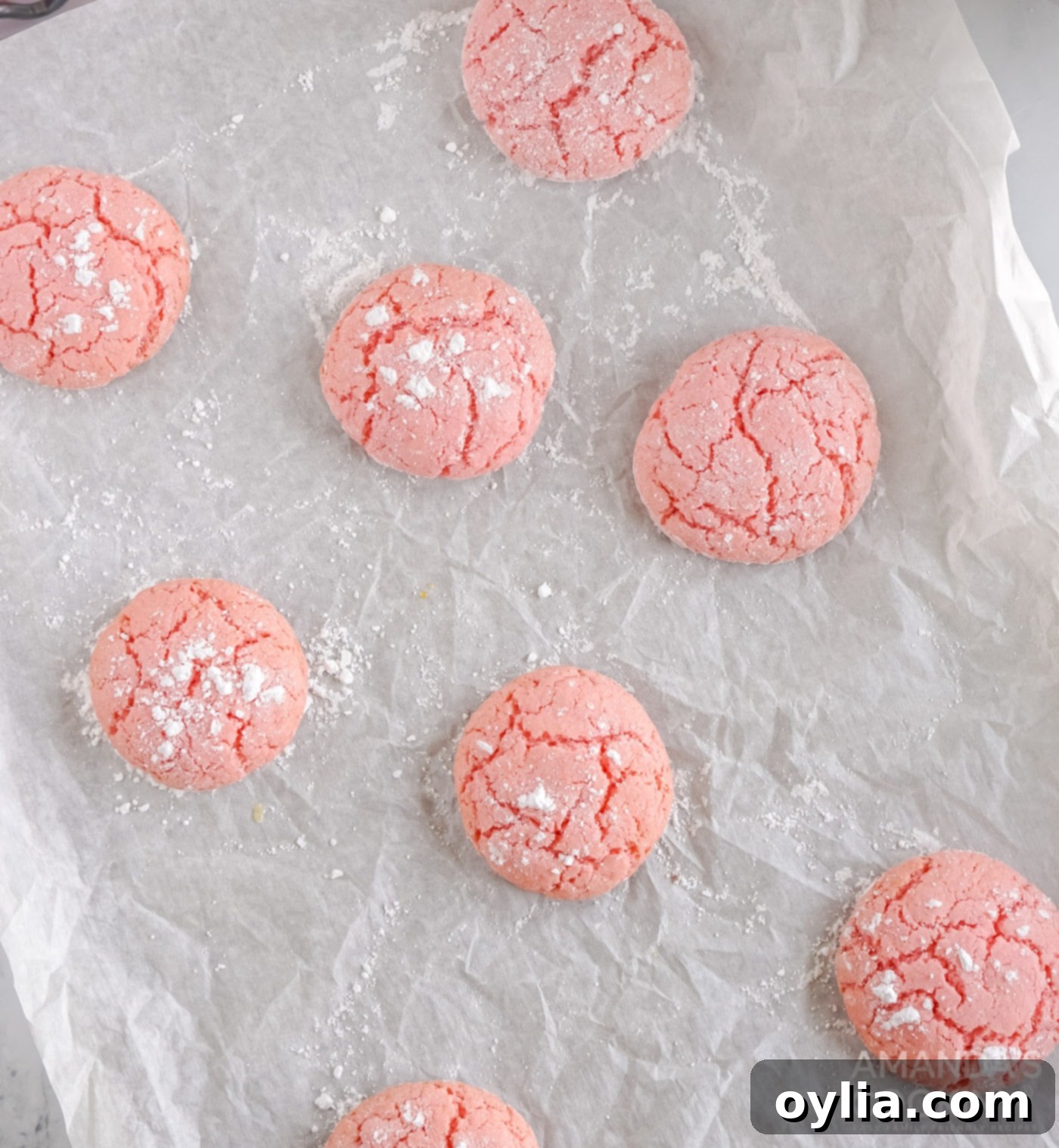 A cookie sprinkled with powdered sugar on top of the glaze, creating a lovely finish.