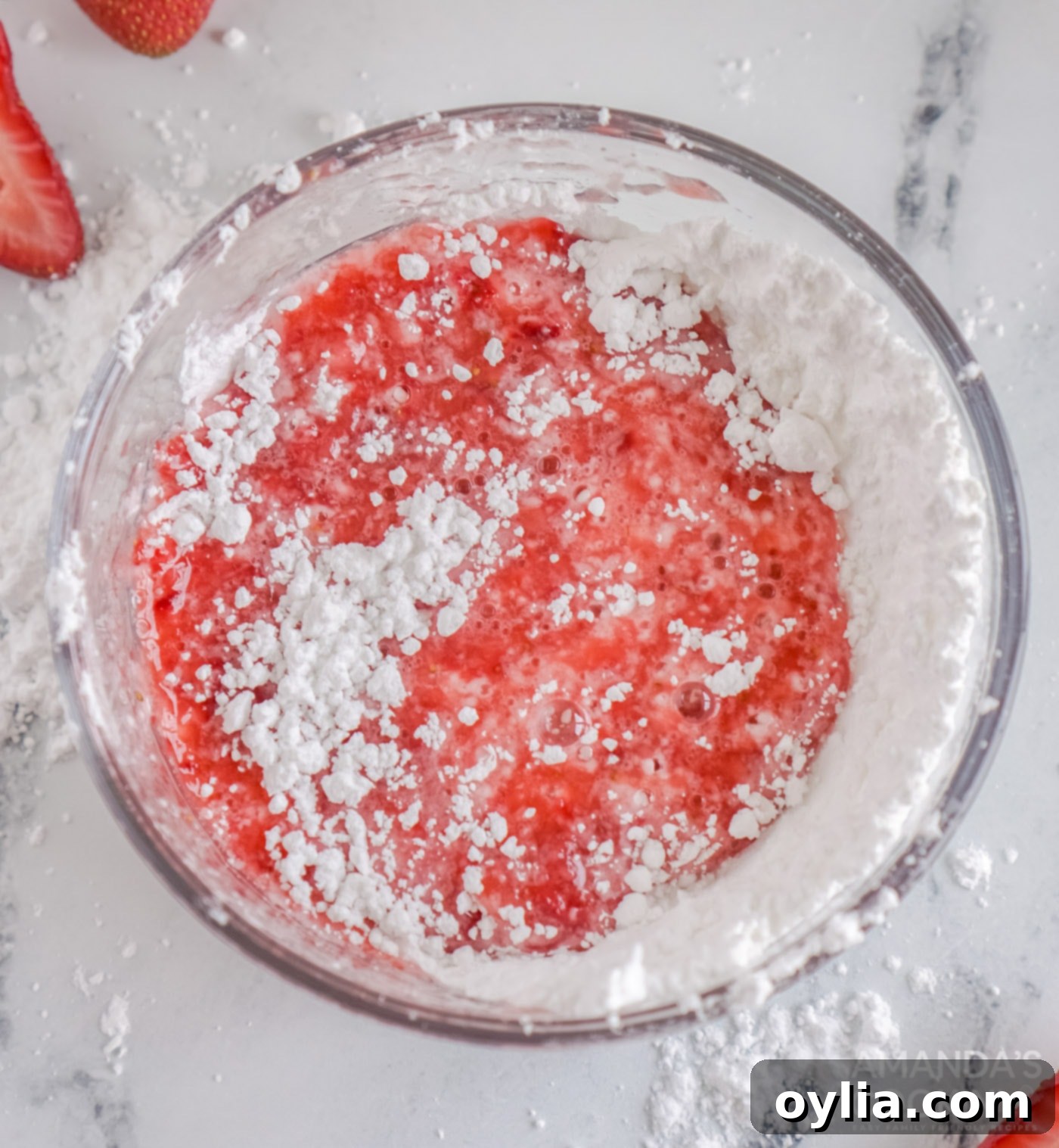 Ingredients for strawberry lemon glaze in a bowl, before mixing.