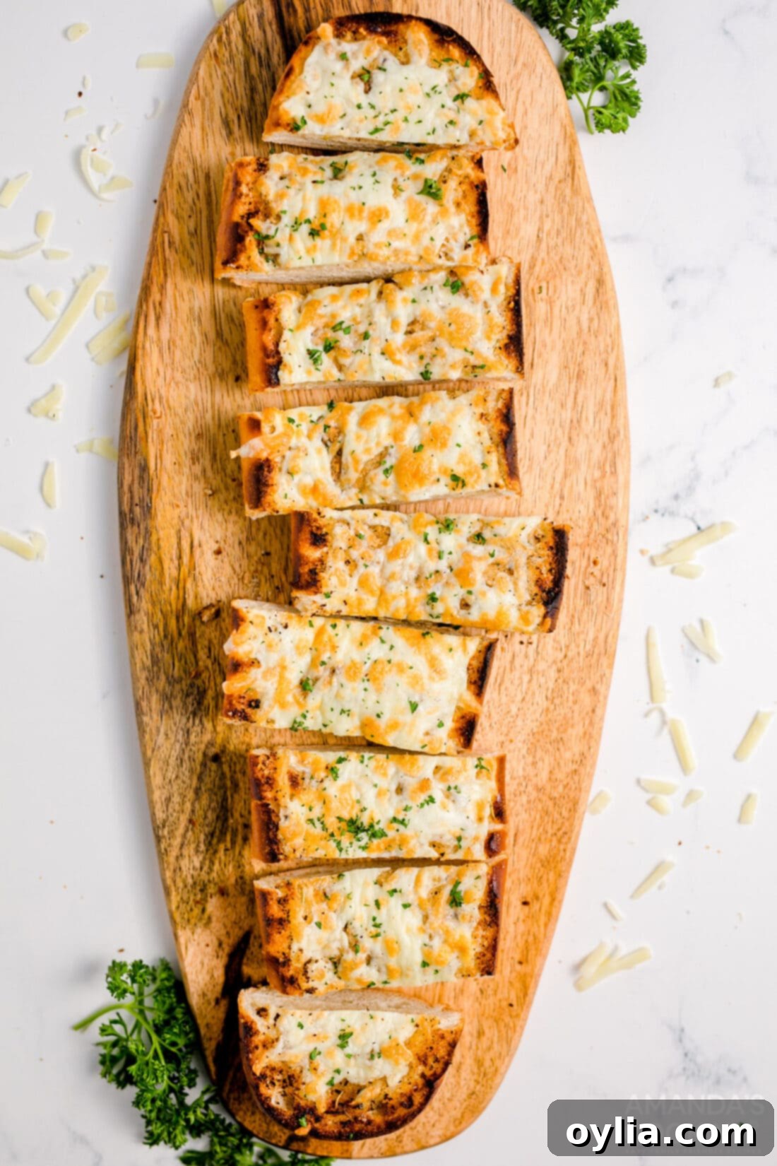 Beautifully sliced Cheesy Garlic Bread arranged on a wooden cutting board