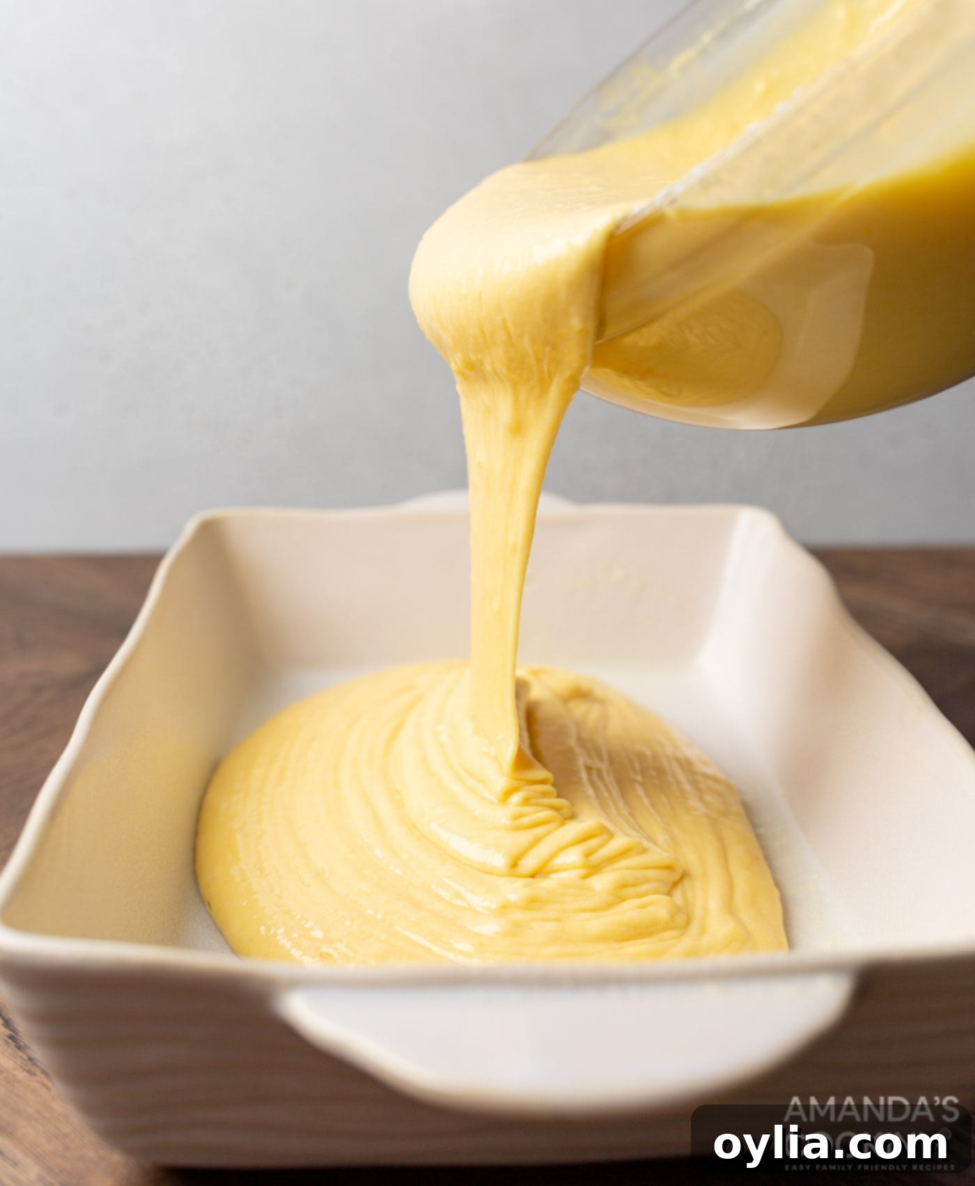 pouring cake batter into pan