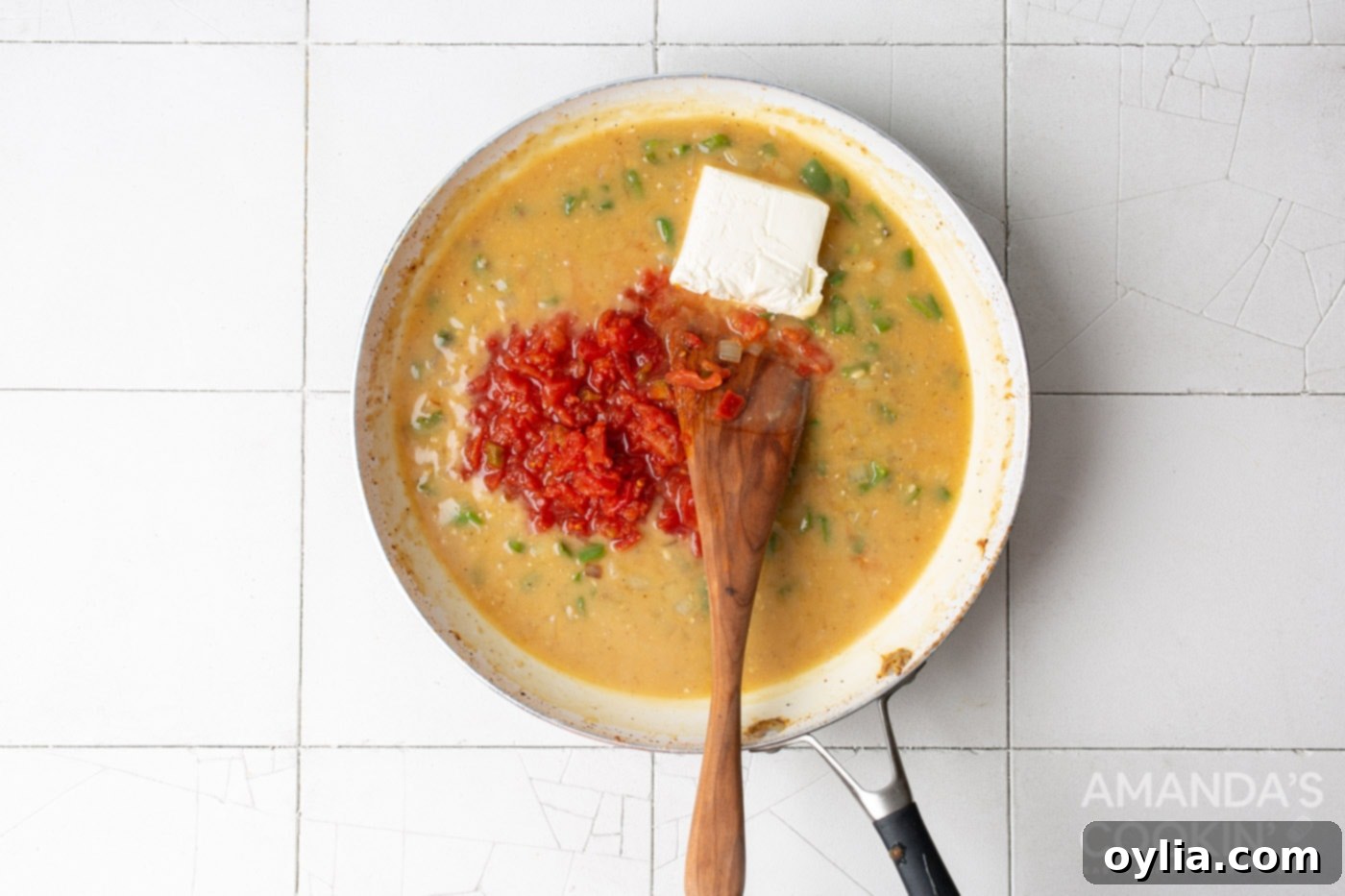 chicken broth, rotel tomatoes, and cream cheese in skillet