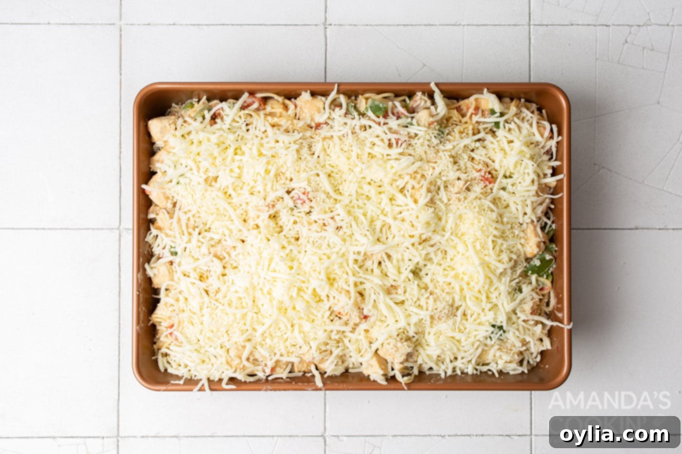 shredded cheese on top of chicken spaghetti casserole