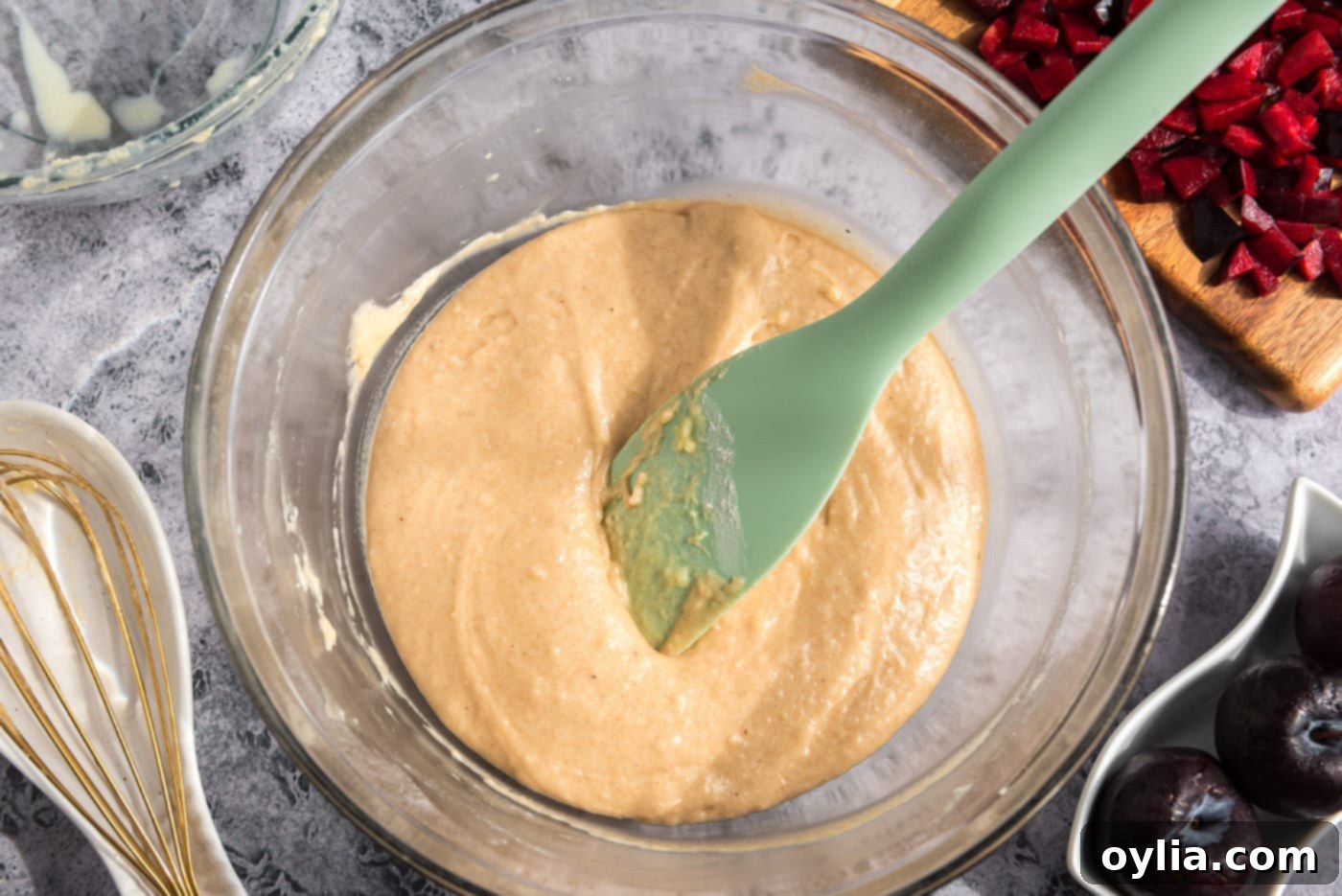 Smooth, well-mixed plum muffin batter in a large bowl, ready for the next steps.