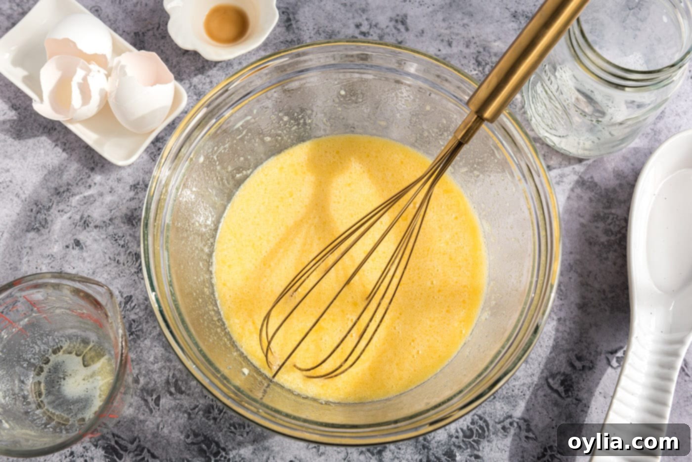 The fully whisked and combined egg and milk mixture in a bowl, appearing smooth and ready for the dry ingredients.