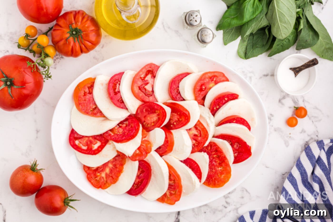 sliced tomatoes and mozzarella arranged on a plate