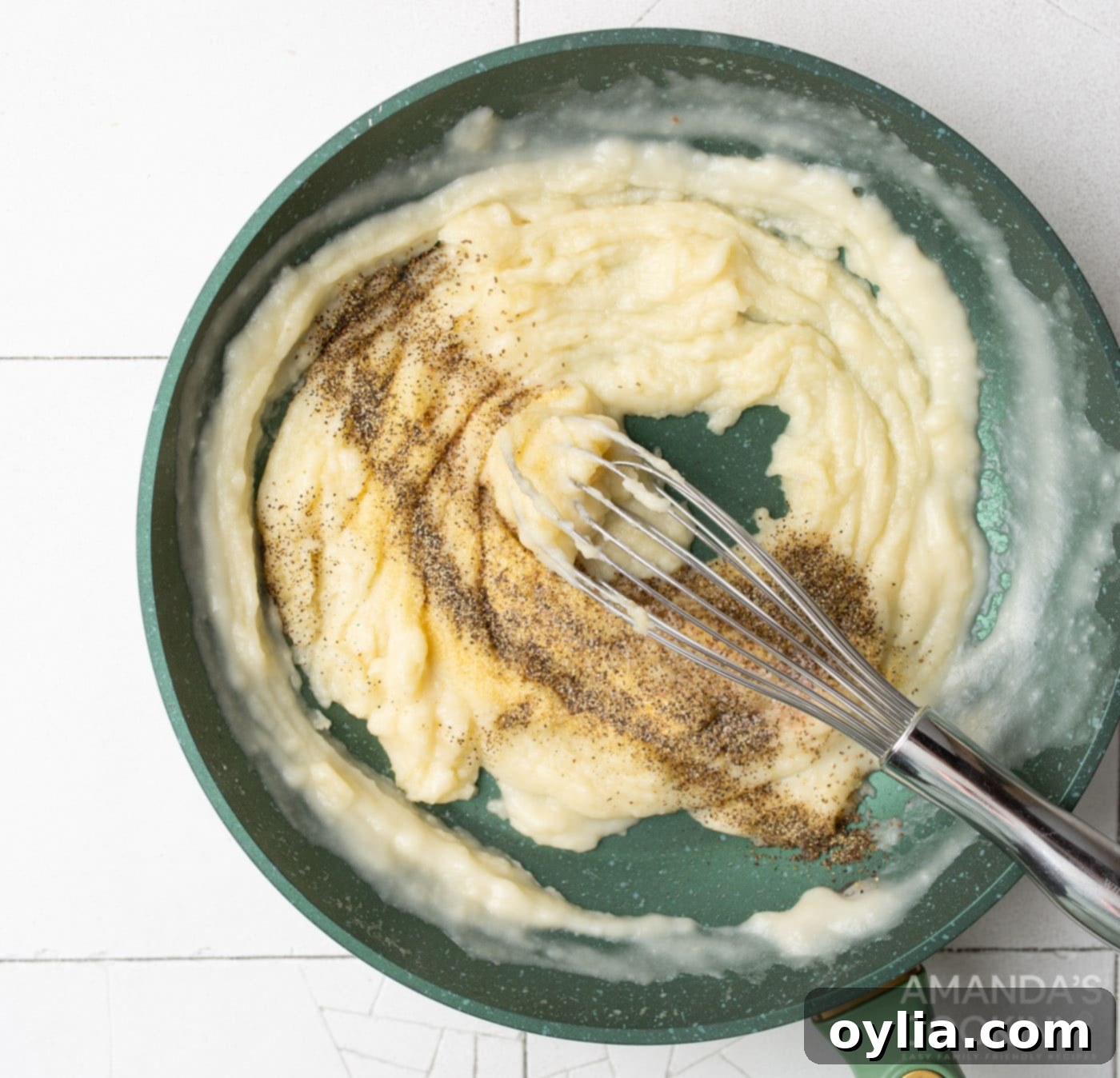 spices being whisked into cream of chicken soup mixture on a skillet