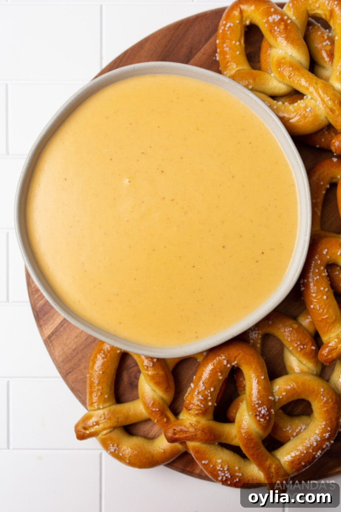bowl of Beer Cheese Dip surrounded by pretzels, ready to serve