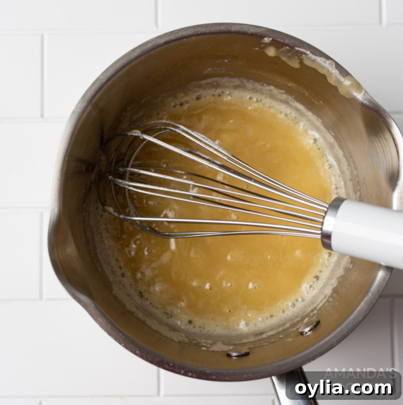 whisking butter and flour in a saucepan to make a roux