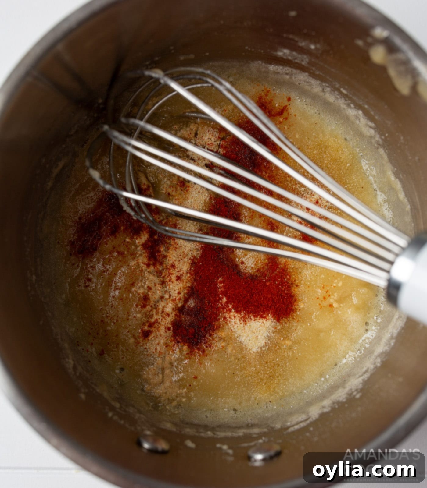 whisking spices into butter and flour roux for beer cheese dip