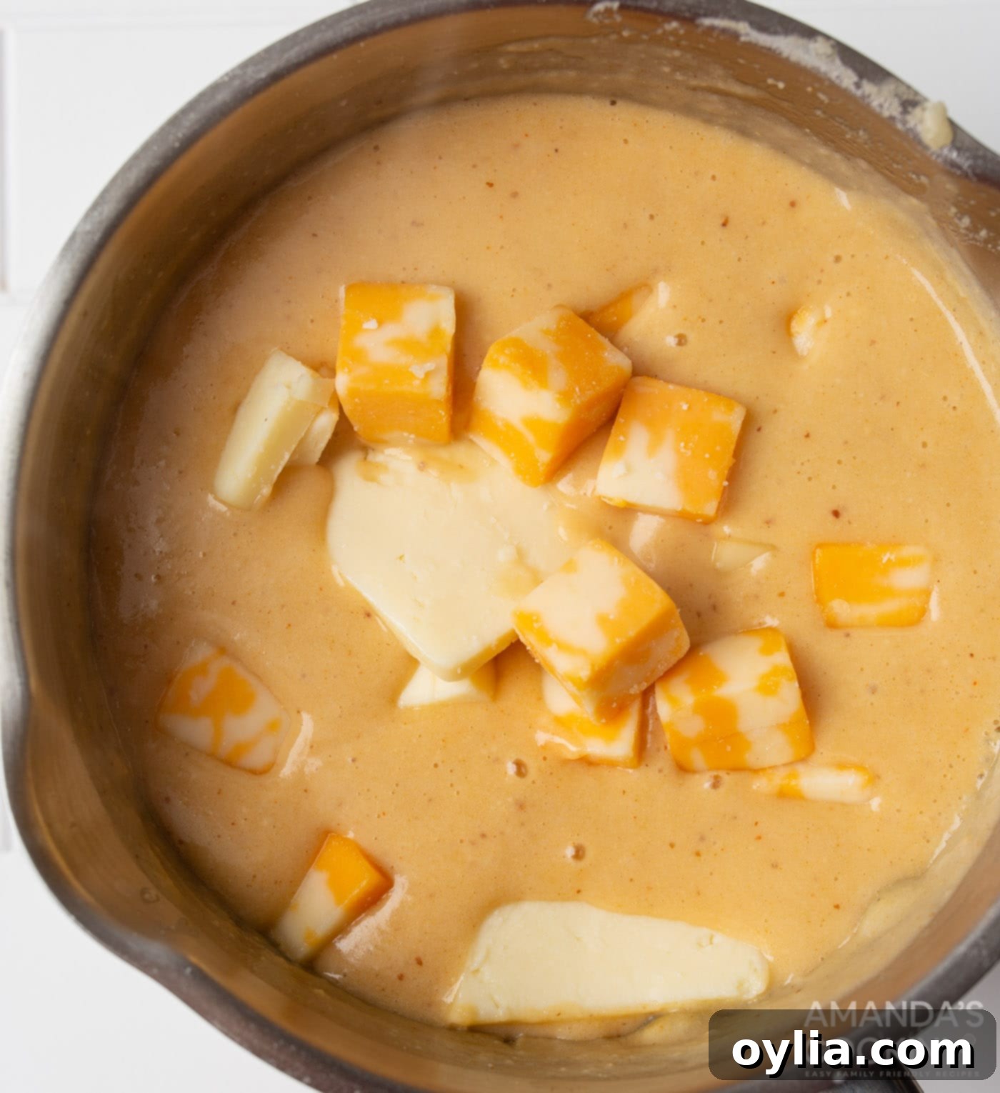 cubed cheese melting into the beer and milk roux