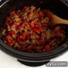 Slow Cooker Comfort Chili 8 Close-up of hearty chili simmering in a crockpot, showcasing its rich texture and color, inviting you to taste its slow-cooked perfection.