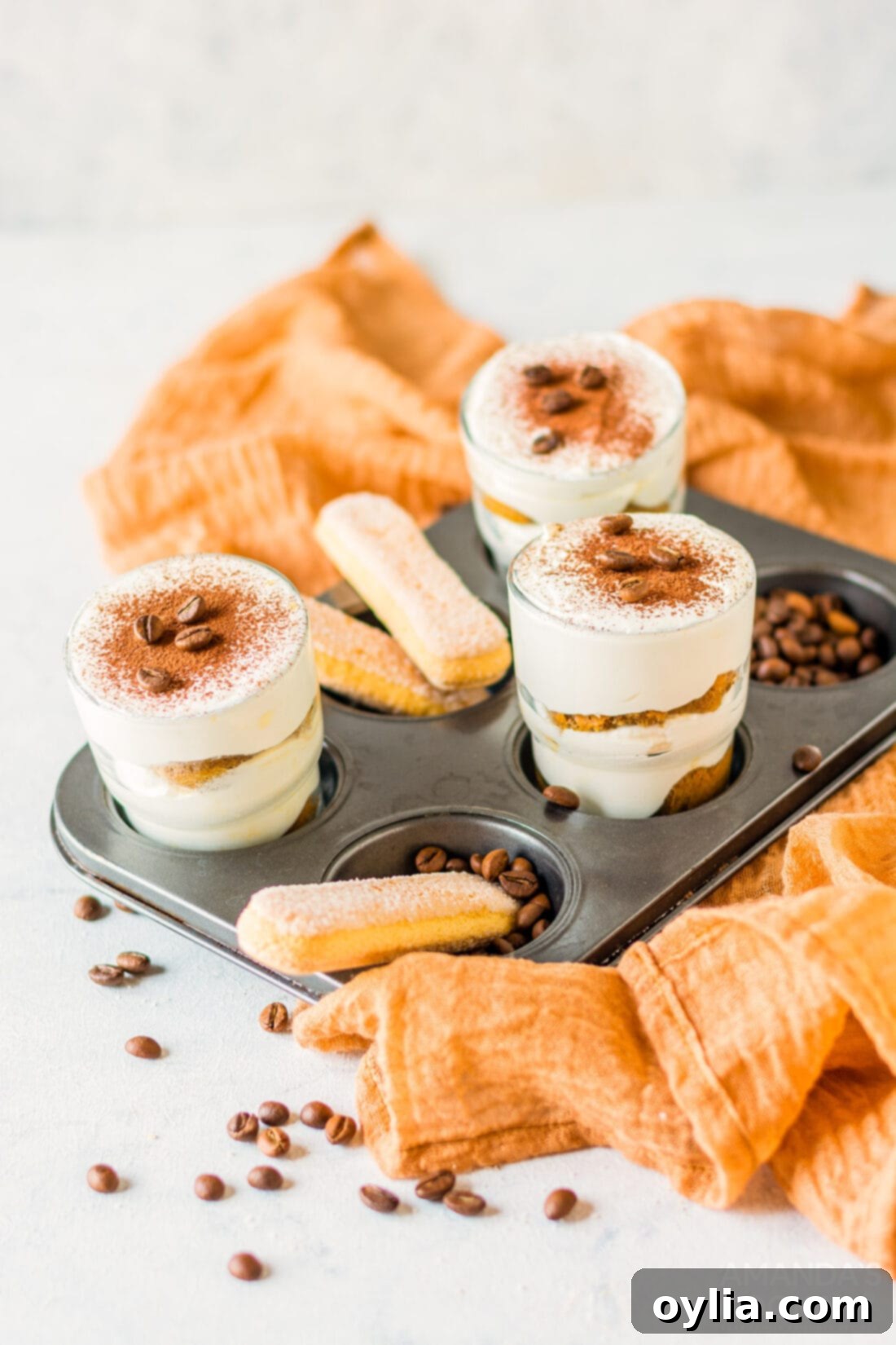 Tiramisu for One 3 Individual Tiramisu cups neatly arranged in a muffin tin, ready to chill, showing the beautiful layers.