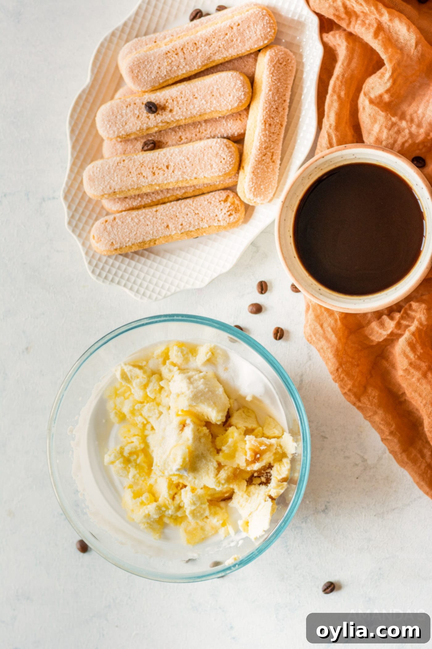 A bowl of creamy mascarpone cheese mixture, prepared for the tiramisu layers.