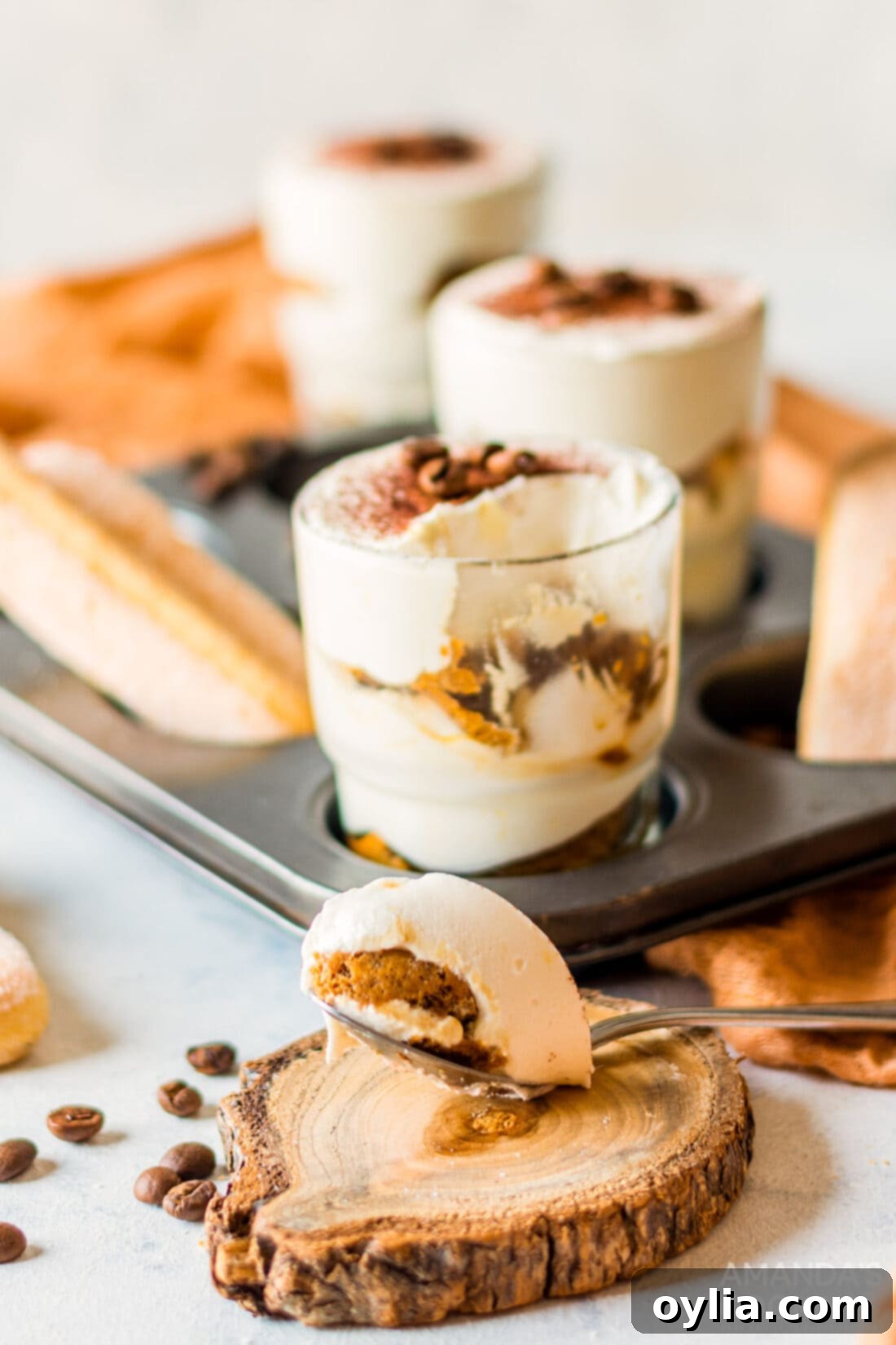 Tiramisu for One 10 A delightful individual tiramisu cup, with a spoonful removed, revealing the perfect layers of cream and espresso-soaked biscuit.