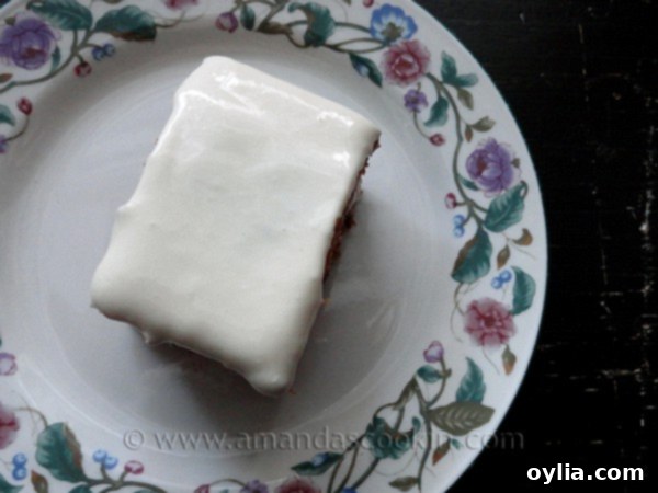 An overhead photo of a square of low fat carrot cake on a decorative plate.
