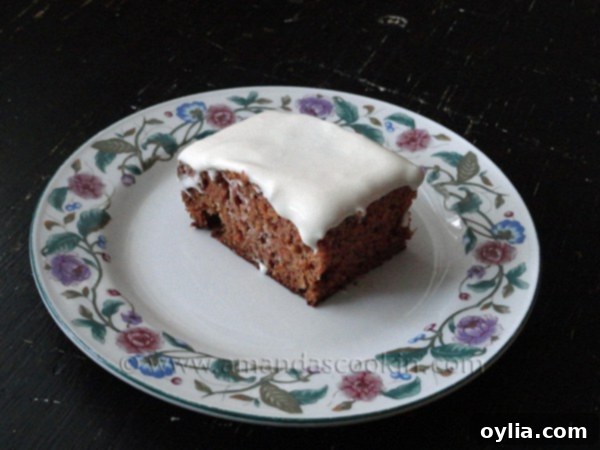 A photo of a square of low fat carrot cake on a decorative plate.