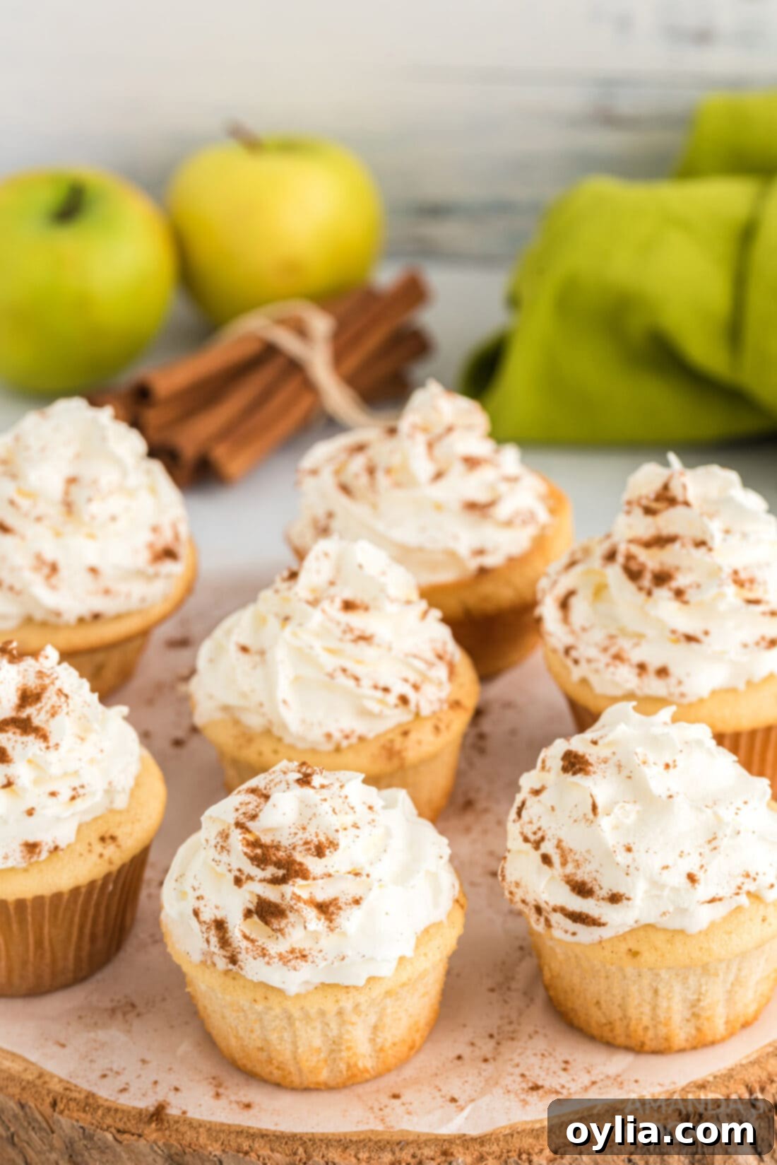 A batch of freshly baked 3-Ingredient Apple Pie Cupcakes on a cooling rack, showcasing their golden-brown tops.