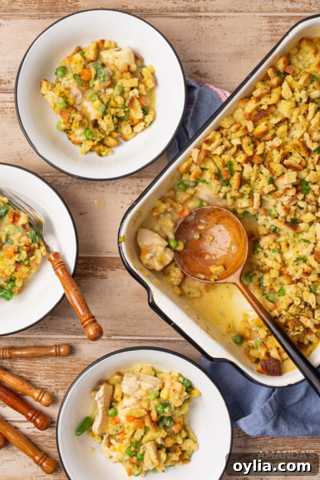 pan of Chicken Stuffing Casserole with serving dishes, ready to be enjoyed