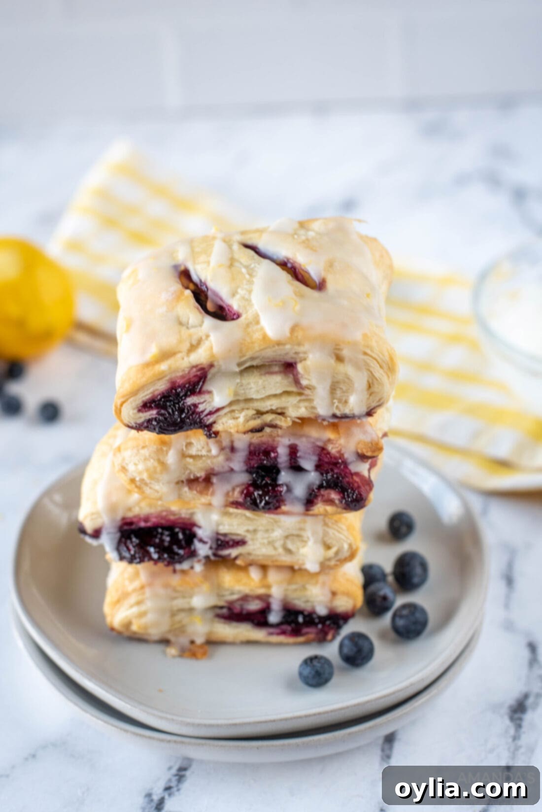 Stacked Lemon Blueberry Hand Pies with a flaky crust and lemon glaze