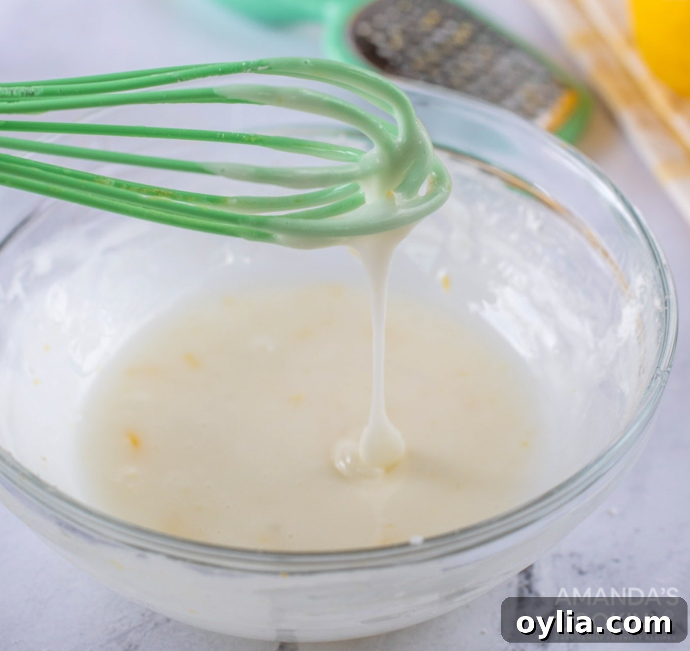 Whisk with smooth lemon glaze mixture