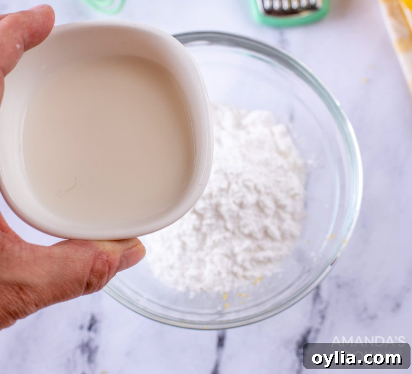 Pouring milk into powdered sugar for the glaze