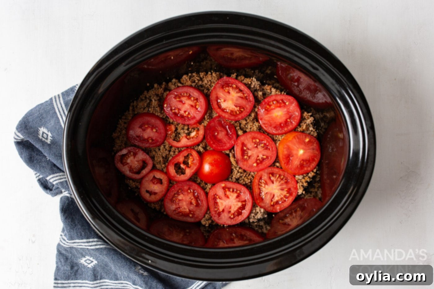 tomatoes on top of ground beef in crockpot