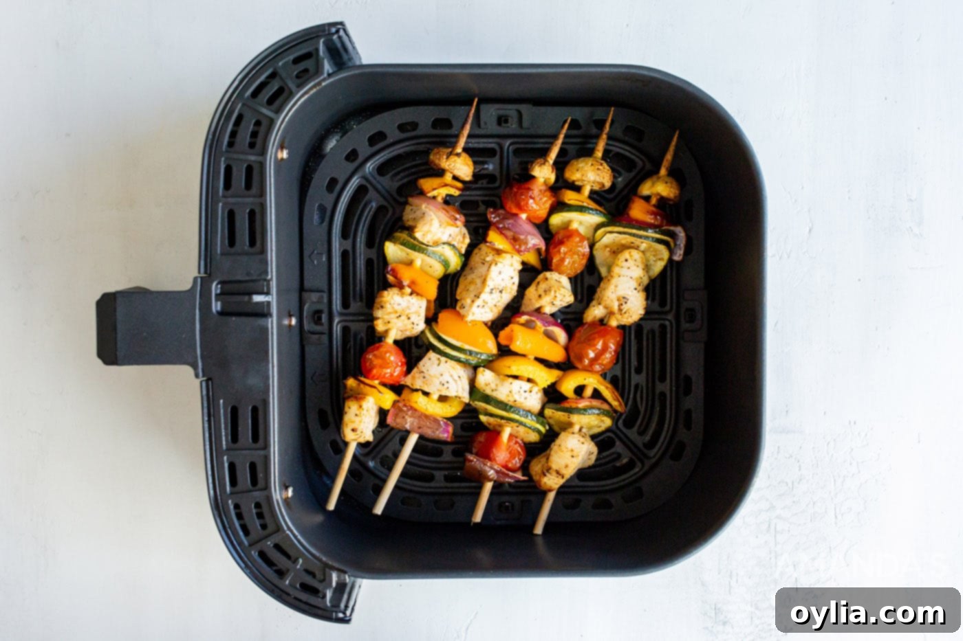 Grilled chicken kabobs in an air fryer basket