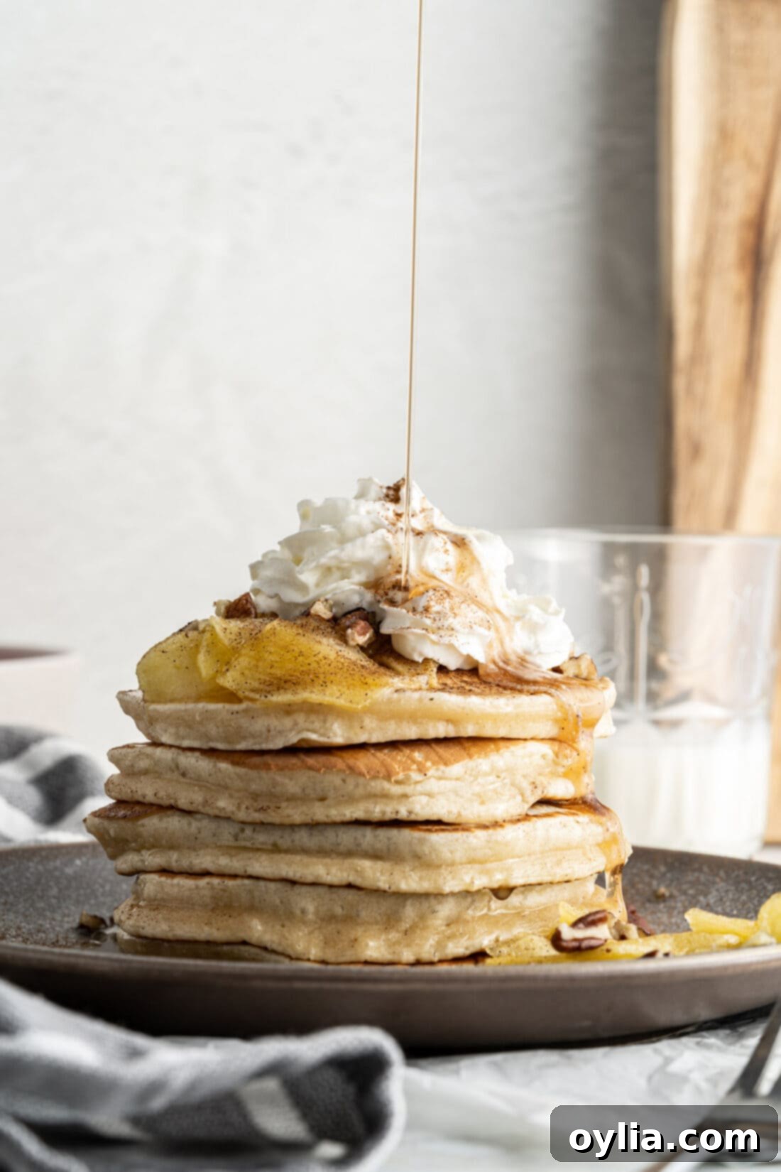 Fluffy Apple Pancakes 2 drizzling syrup onto apple pancakes