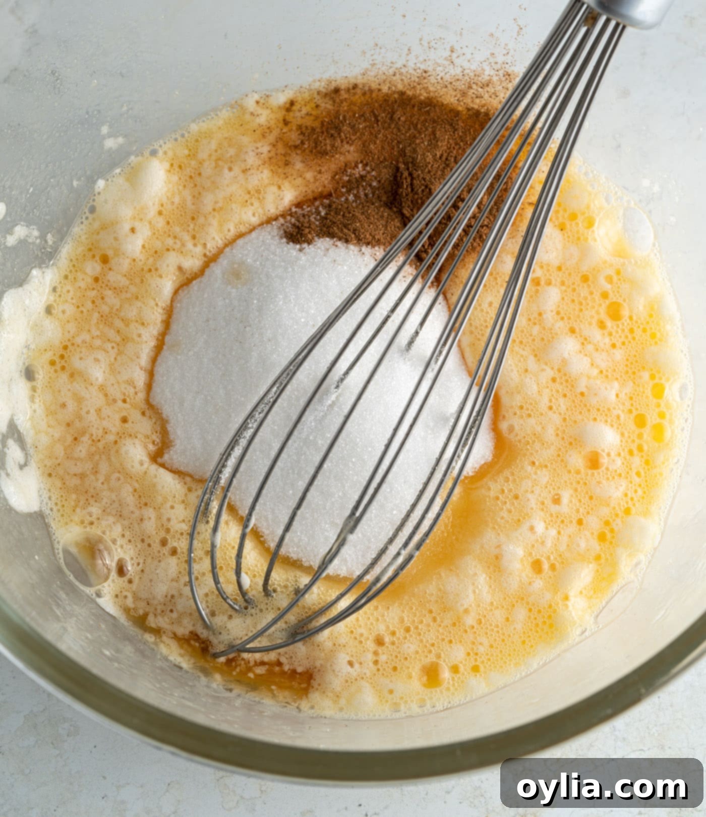 apple pancake batter with a whisk