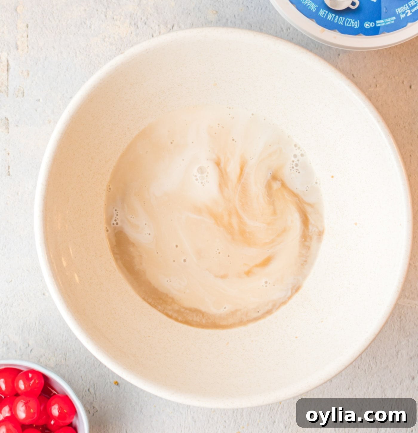 root beer, root beer flavoring, and heavy whipping cream in a bowl