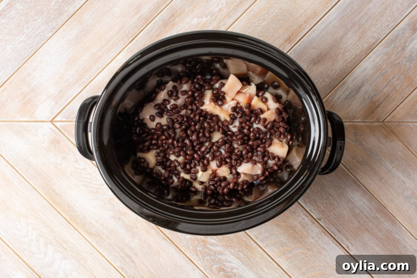 chicken and black beans layered in a slow cooker