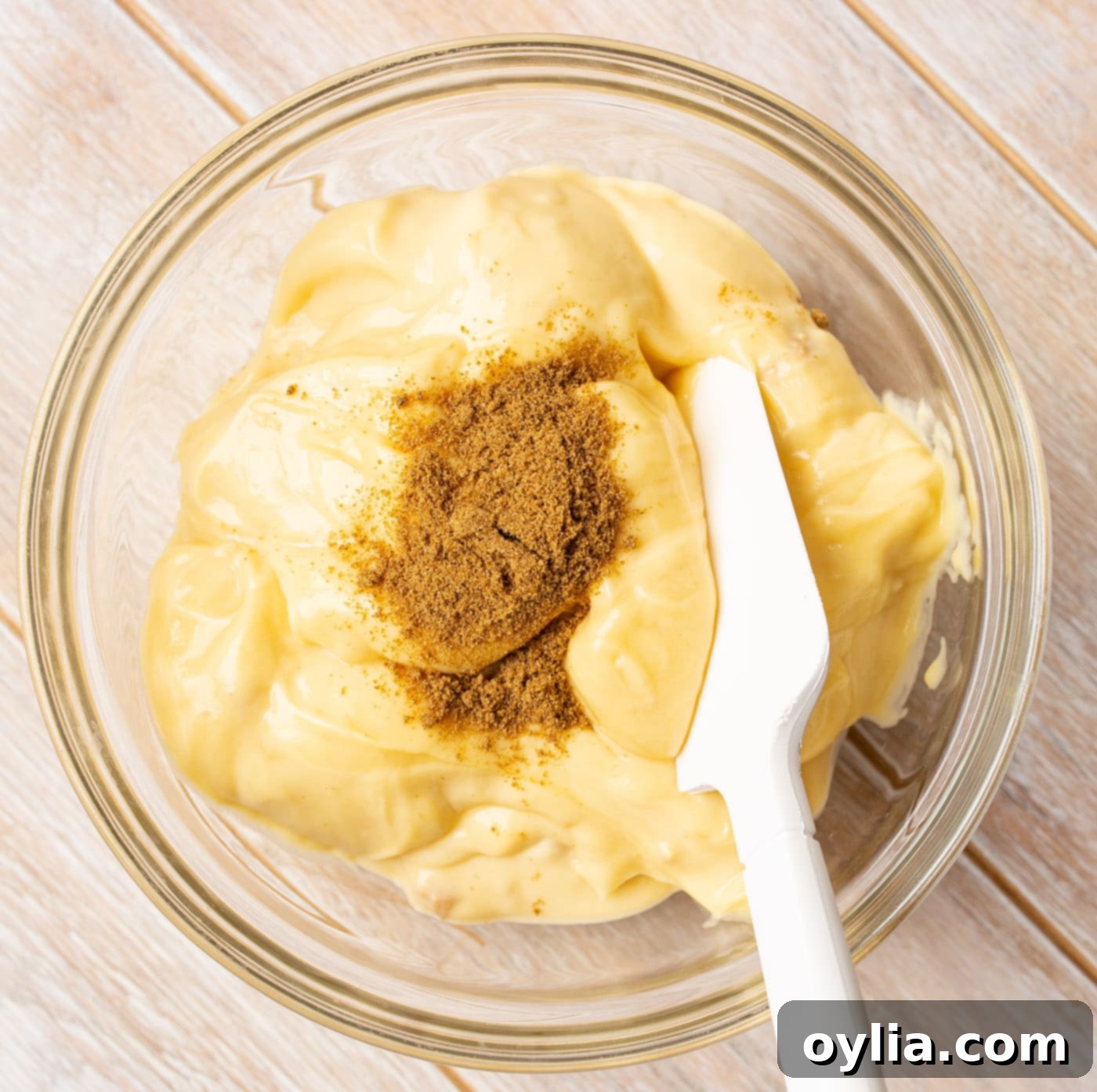 spatula mixing cream of chicken soup with cumin in a bowl