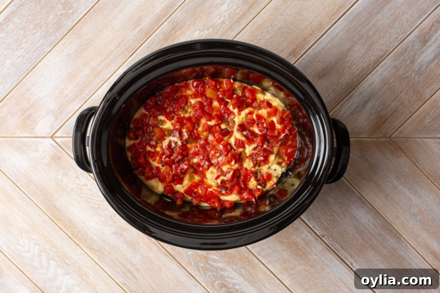Rotel tomatoes added on top of cream of chicken soup and black beans in a slow cooker