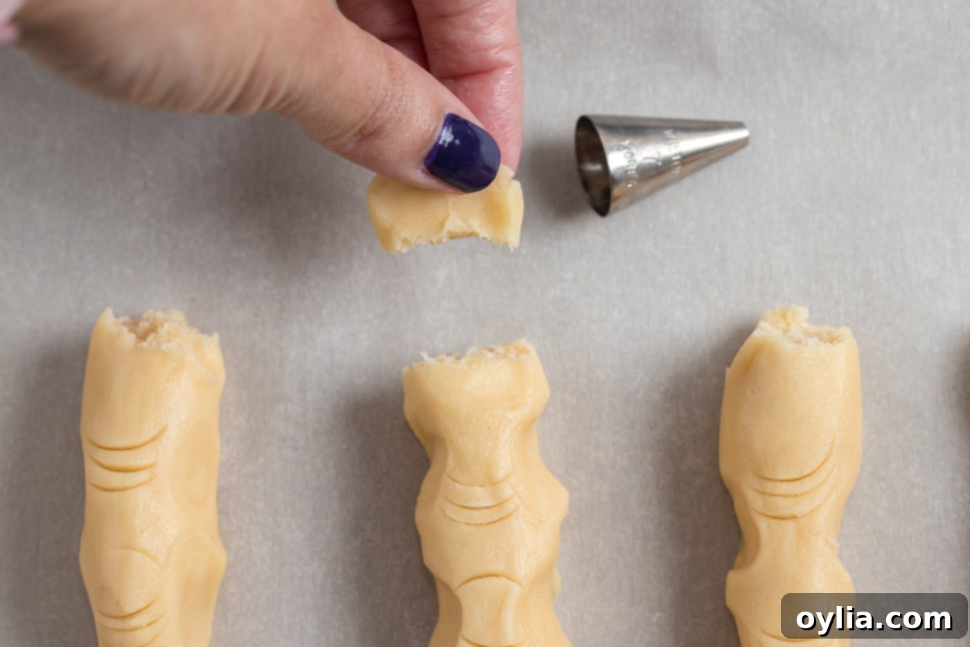 breaking off end of witch finger cookie dough