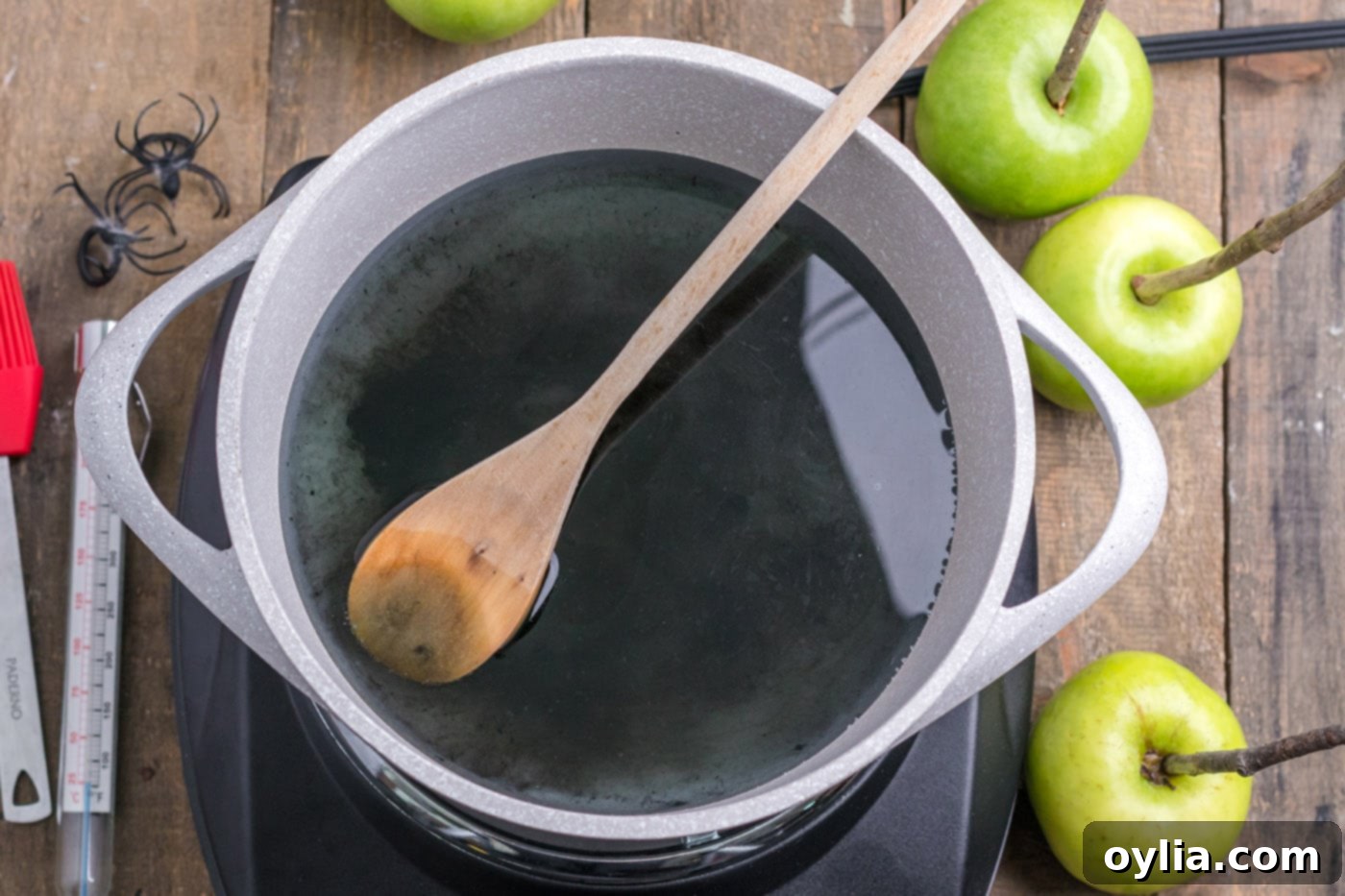 corn syrup, water, sugar, and black icing gel in a pot