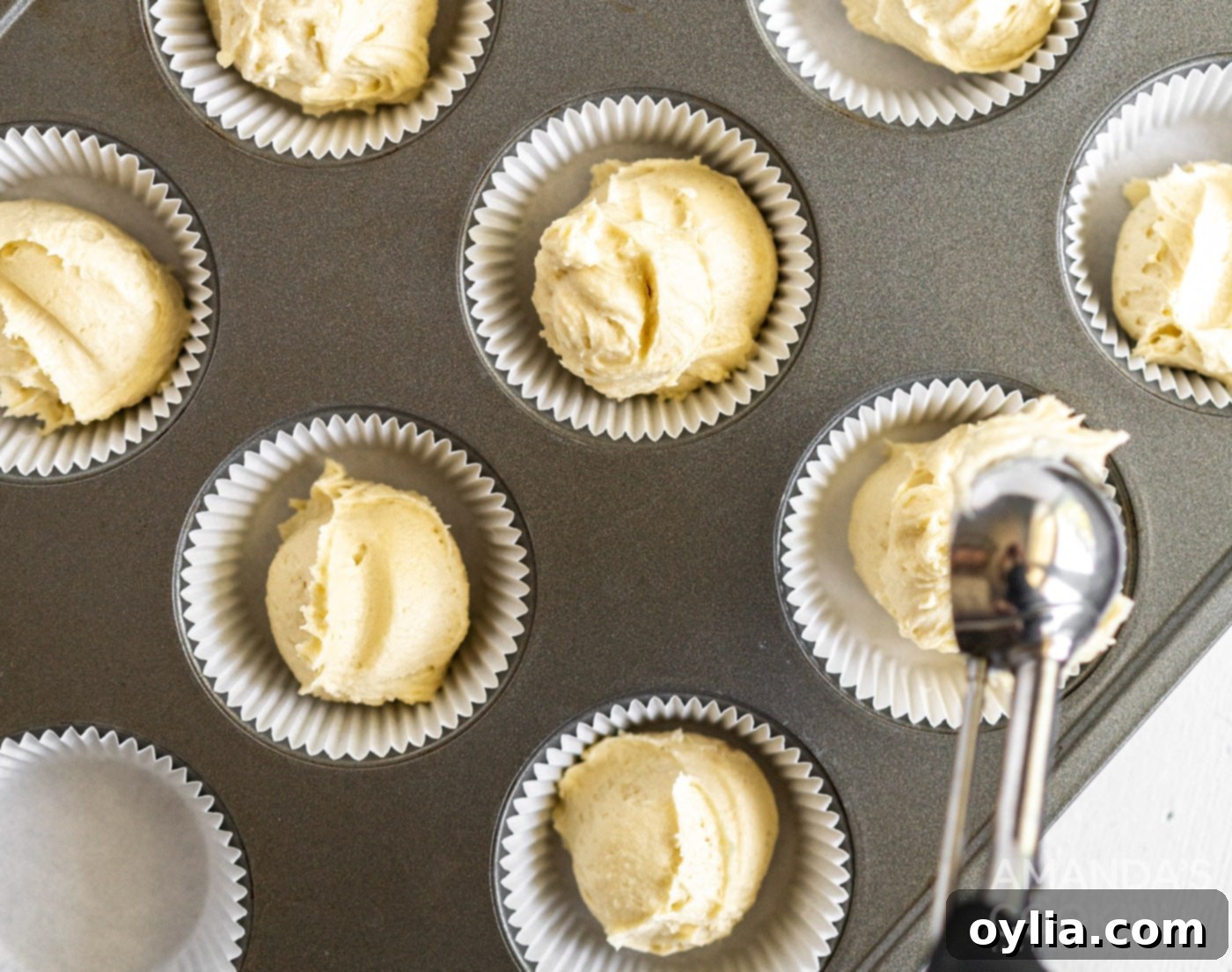 pound cake batter spooned into muffin tin