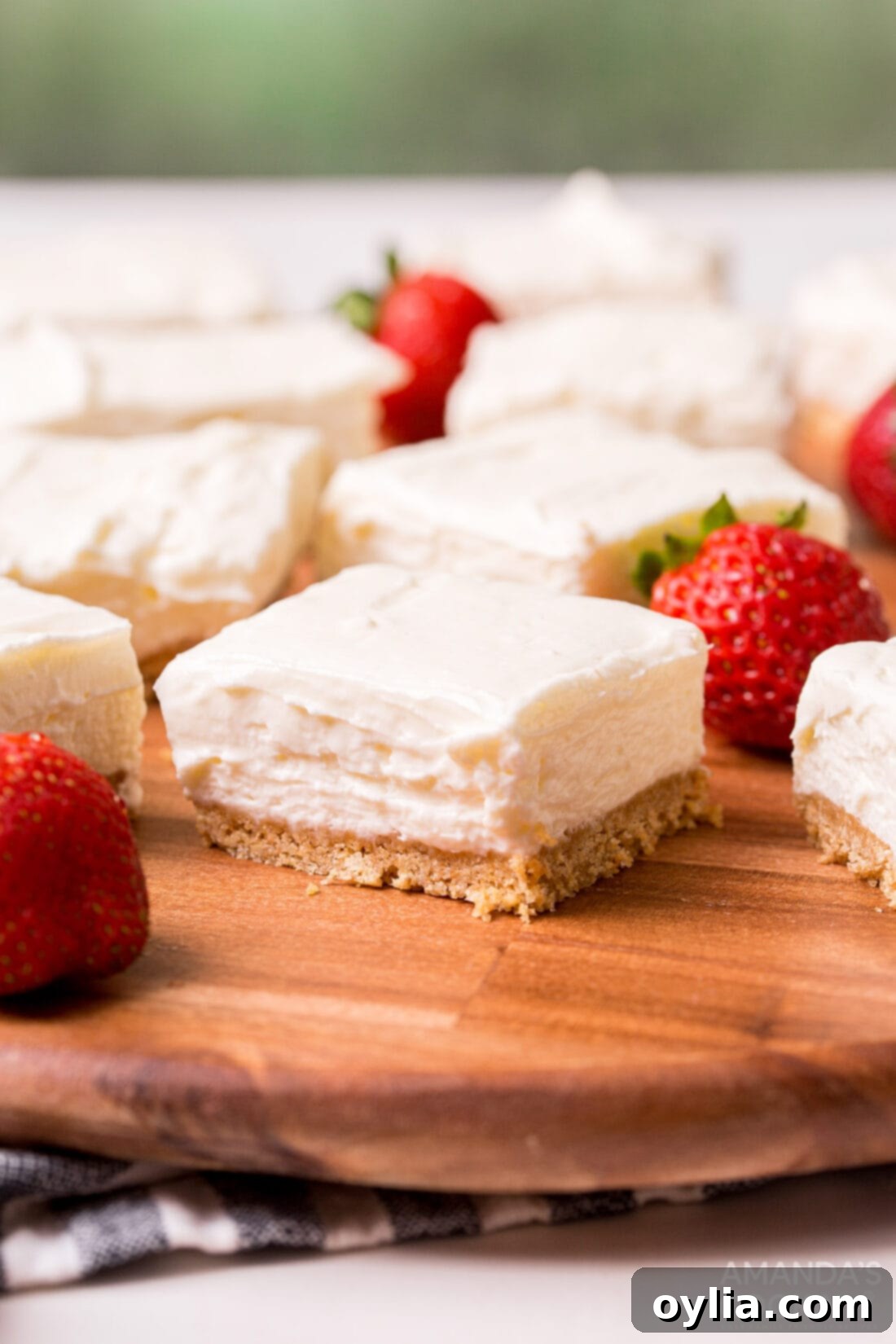 Creamy No Bake Cheesecake Bars perfectly sliced on a rustic cutting board, ready to serve