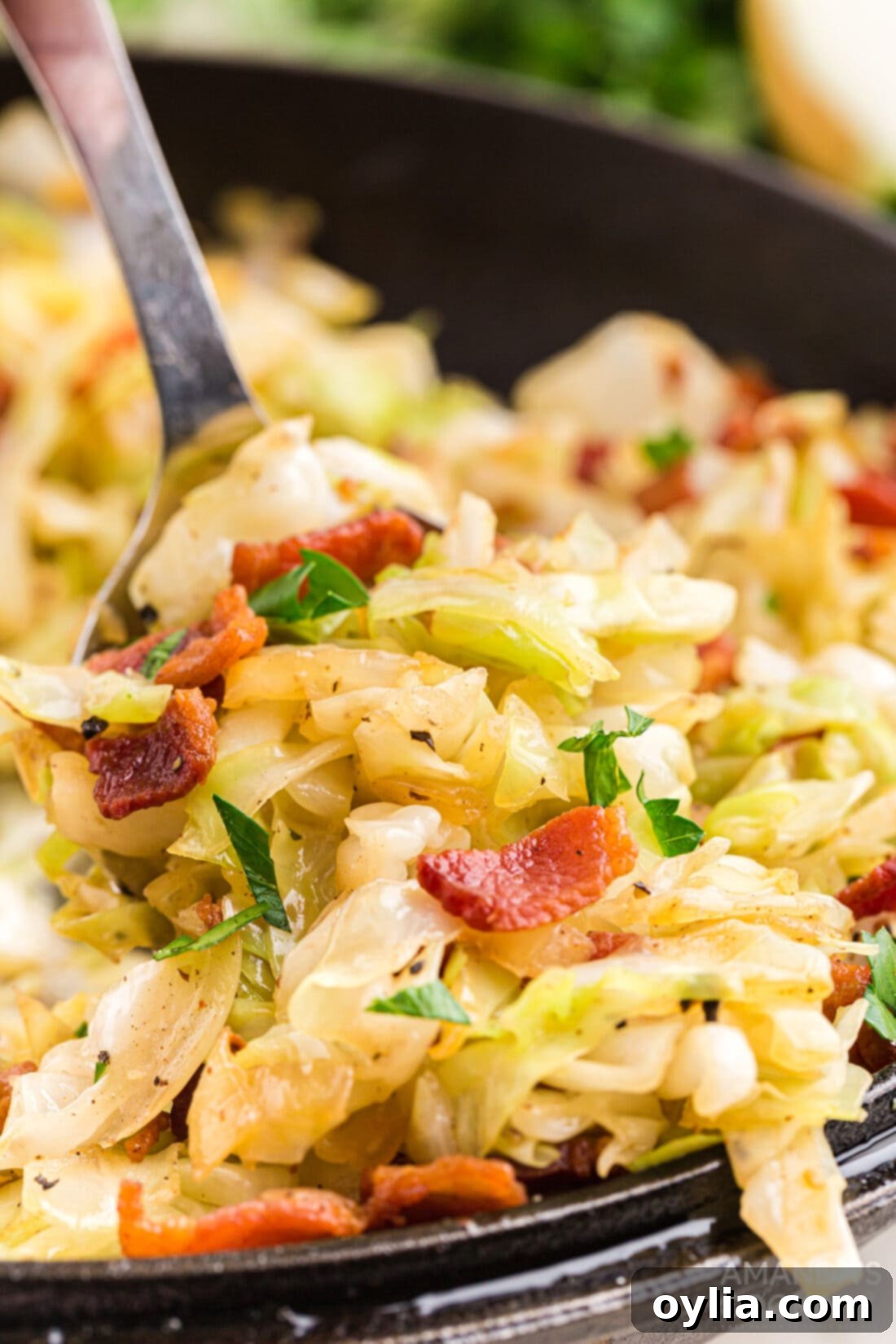 spooning out Fried Cabbage