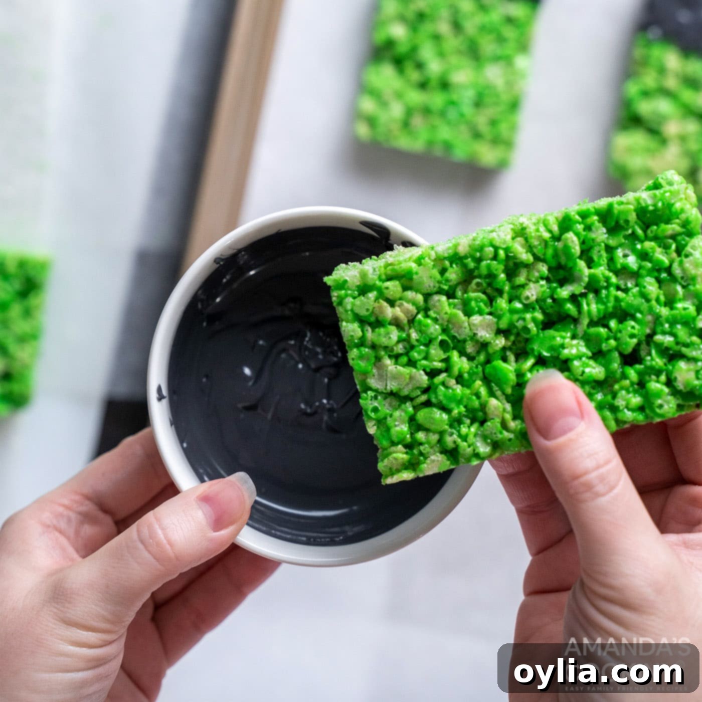 Monster Mash Krispie Treats 13 hand dipping green rice krispie treat into candy melts