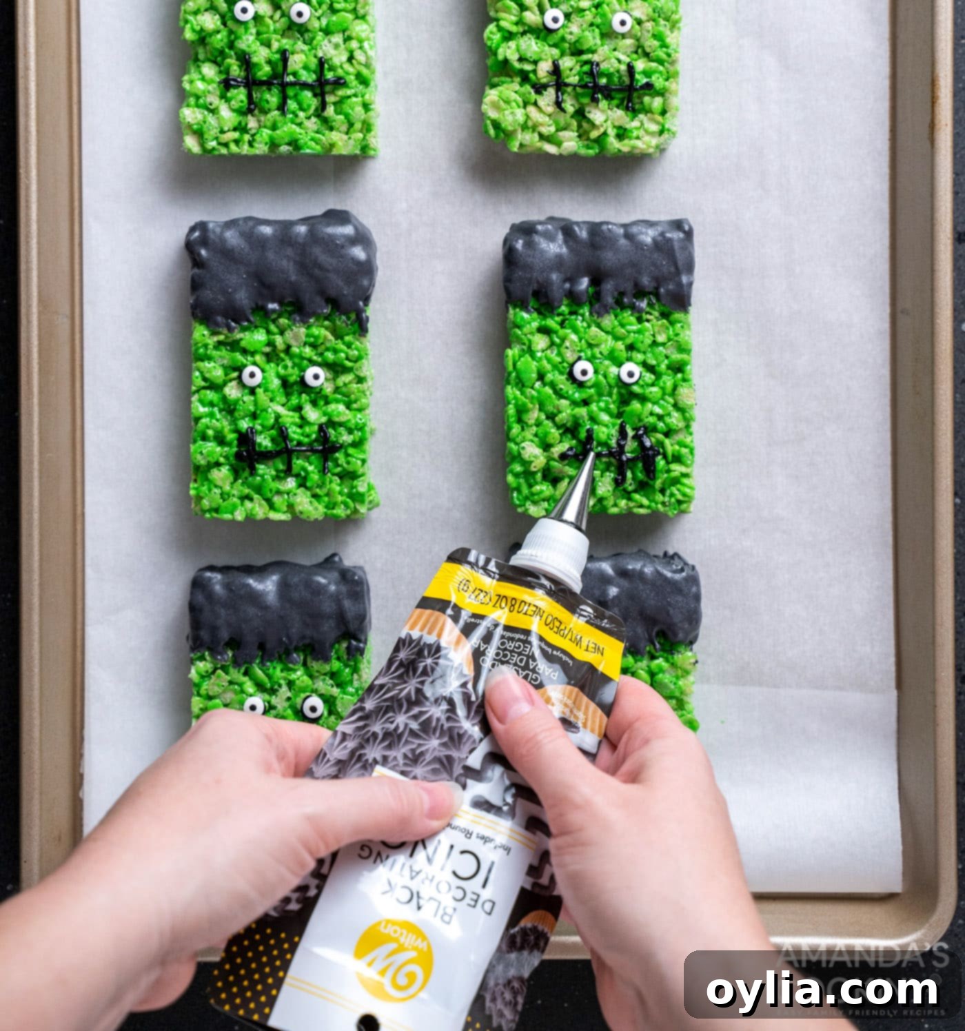 Monster Mash Krispie Treats 14 piping on frankenstein mouths to rice krispie treats